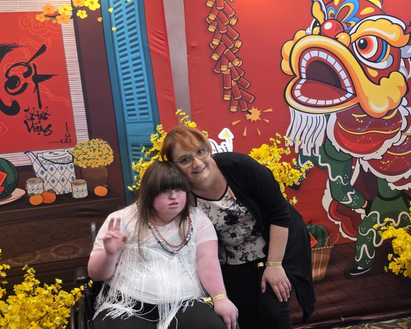Oina and Emily in front of a Tết display