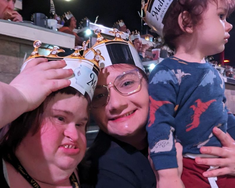 Oina and Emily in paper crowns at Medieval Times